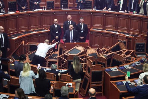 Albanian opposition politicians throw firecrackers and chairs in parliament protest